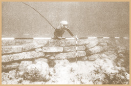 A diver measuring a wall in the ruins of the sunken city od Dwarka