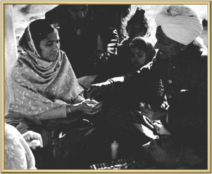 Dr Mool Raj, the ashram homoeopathic physician, dispensing medicine.