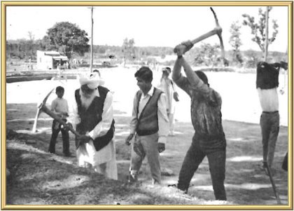 In this picture the Master is seen instructing a young man in the art of wielding a pickaxe.