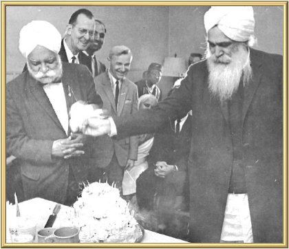 Kirpal Singh is waving His handkerchief over the cake putting all candles out at once.