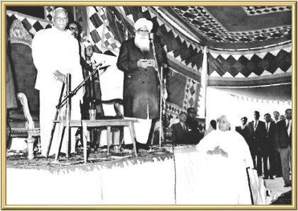 The President, the Master, Bibi Hardevi, and the President’s entourage stand during the singing of the National Anthem by the ladies from the Women’s Training Centre for the Blind, Rajpur.